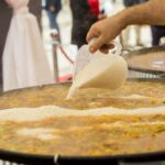 What is bomba rice and why is it preferred by paella masters?